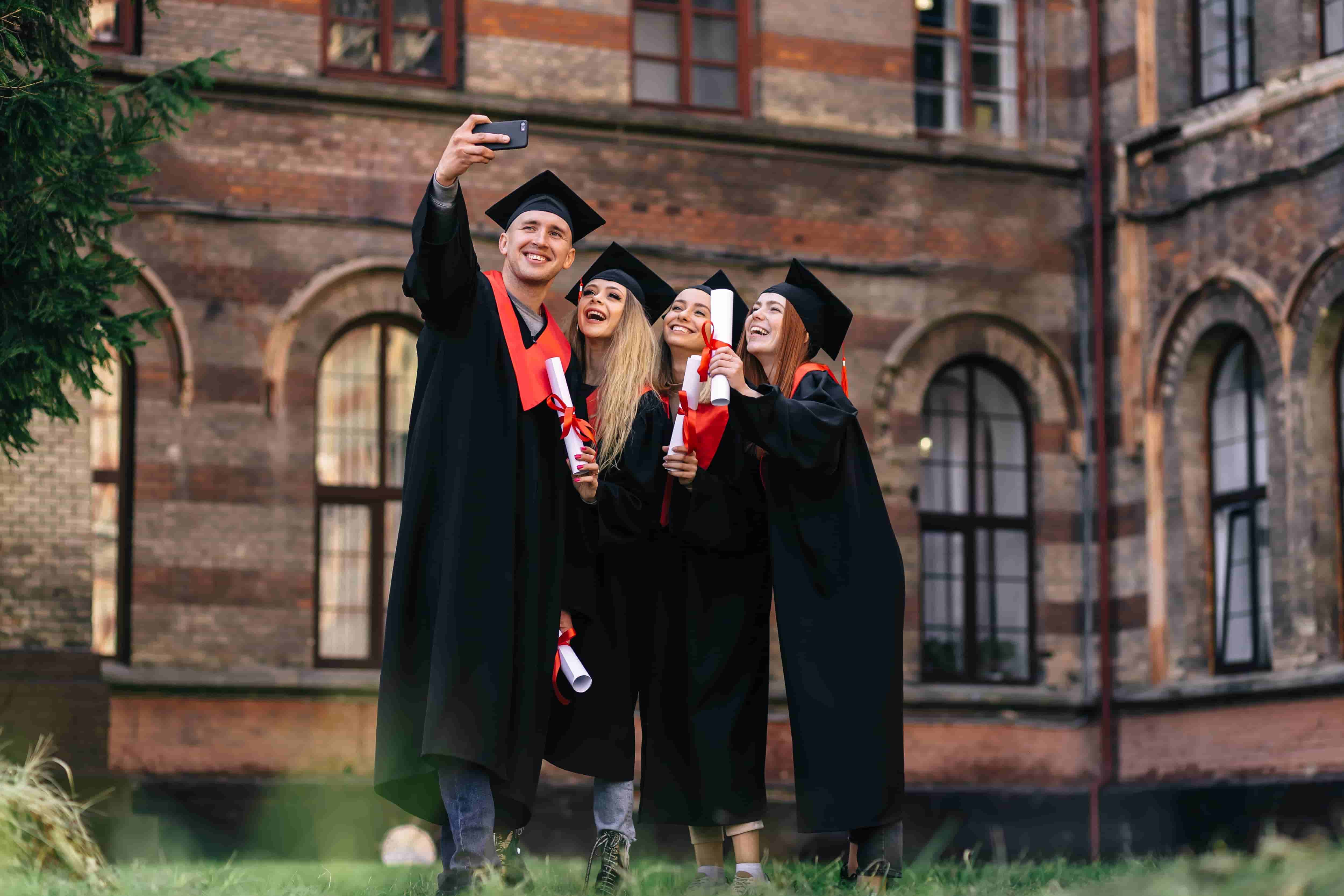 three graduates in caps and gowns