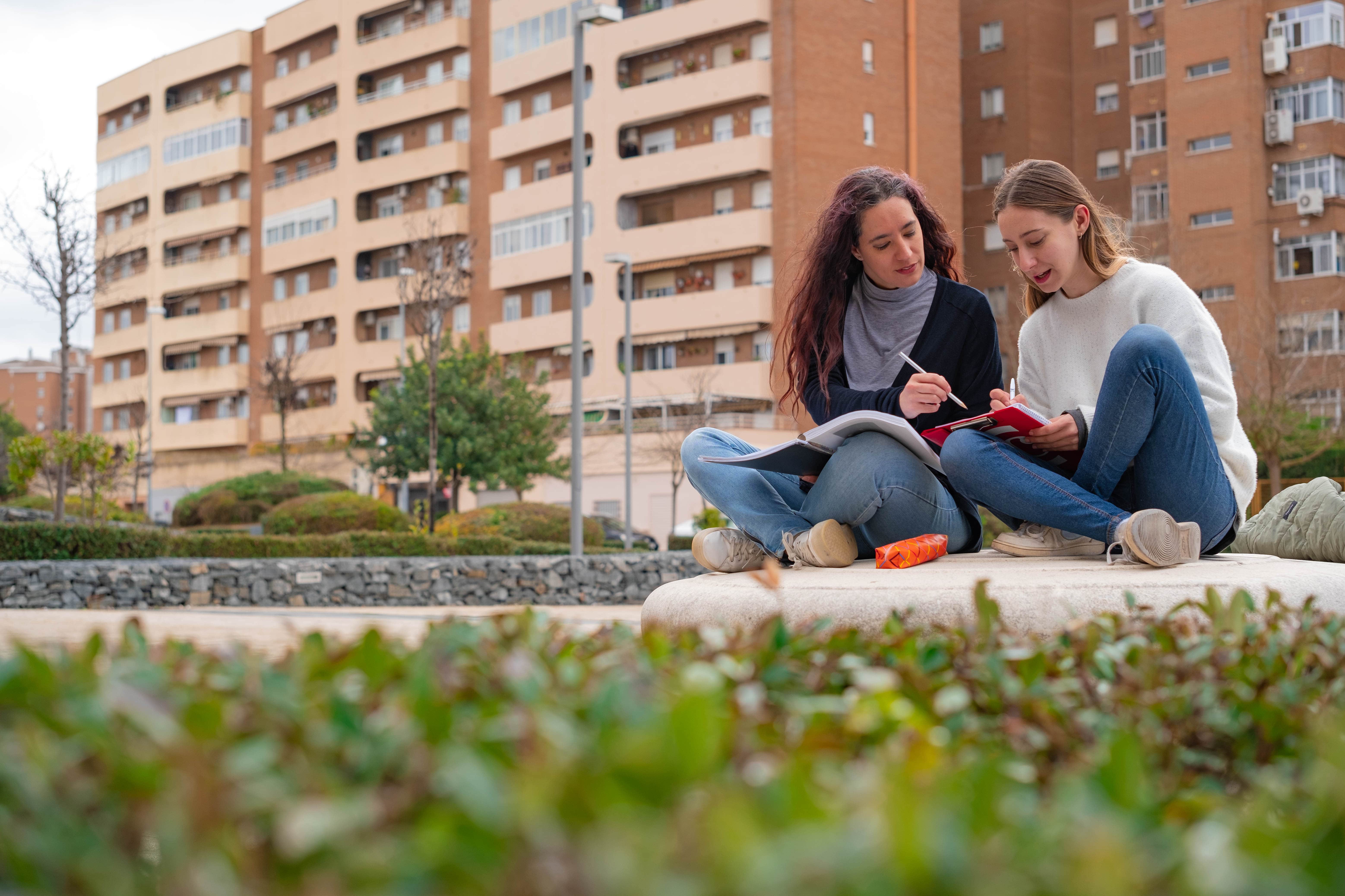 Two students walking in front of Catlett residence hall.